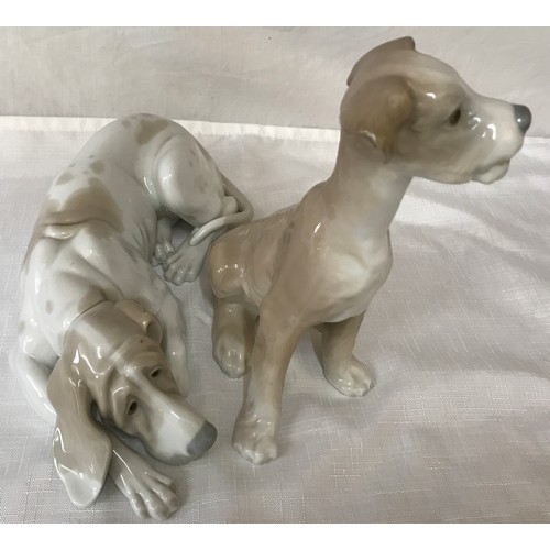 87 - Two large Lladro dogs. Hound 25cm h and a terrier 19cm h.