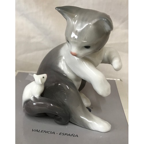 88 - Four Lladro figurines, 2 boxed comprising: Girl washing dog 12cm h, Cat with mouse 8cm h, Santa’s ma... 