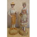 A pair of 19thC continental bisque figurines. 37cm h.