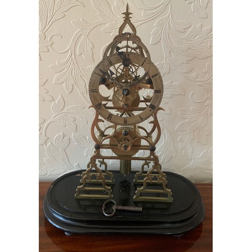 636 - A brass skeleton clock with fusee and cylindrical pendulum. 39cm h.