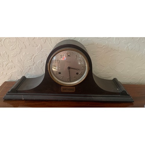 638 - An American mantle clock by Waterbury, Napoleon hat shape. 26 h x 57cm w.