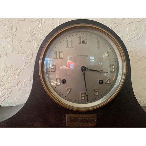 638 - An American mantle clock by Waterbury, Napoleon hat shape. 26 h x 57cm w.