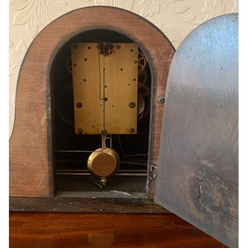 638 - An American mantle clock by Waterbury, Napoleon hat shape. 26 h x 57cm w.