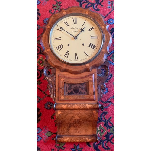 643 - A walnut inlaid drop dial wall clock by JH Cross Brigg.