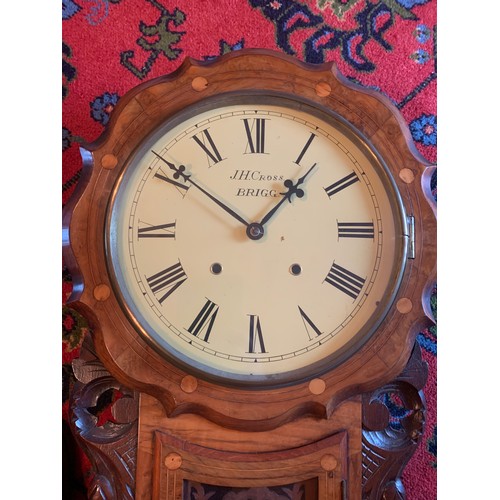 643 - A walnut inlaid drop dial wall clock by JH Cross Brigg.