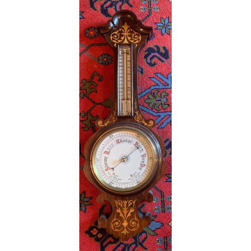 644 - A good quality inlaid rosewood aneroid barometer. 81cm h.