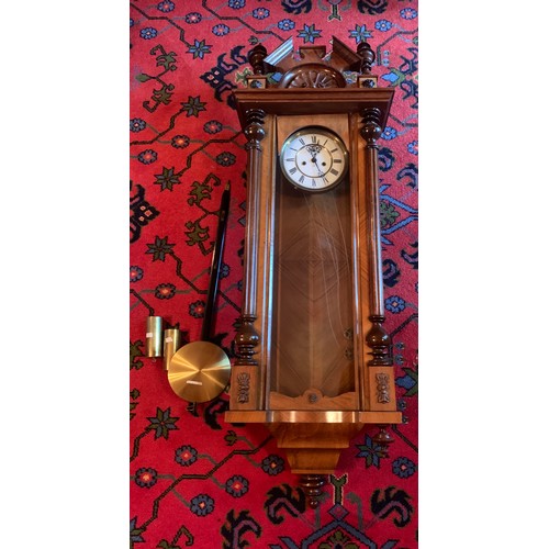 648 - A walnut Vienna twin weight wall clock. 120 cm h.