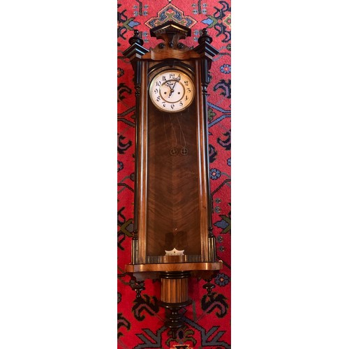 649 - A walnut double weight Vienna wall clock with subsidiary second hand. 119cm h.