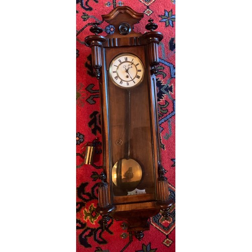 650 - A single weight walnut Vienna wall clock. 85cm h.