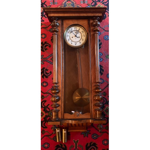 651 - A double weight walnut Vienna wall clock with subsidiary second hand. 127cm.