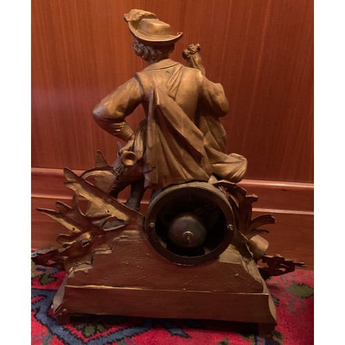 652 - A Victorian gilt metal mantle clock with seated gentleman to top. 42cm h.