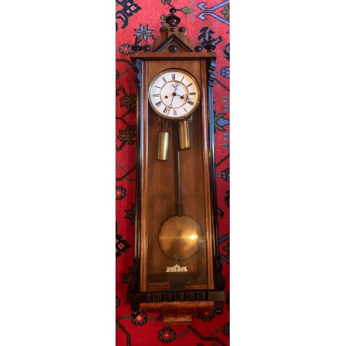 654 - A double weight walnut and ebonised Vienna wall clock with subsidiary second hand dial. 110cm h.