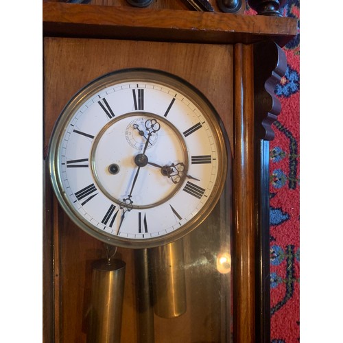 654 - A double weight walnut and ebonised Vienna wall clock with subsidiary second hand dial. 110cm h.