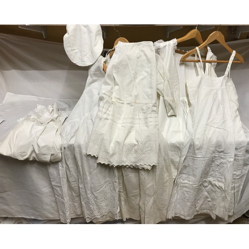 474 - Selection of white linen nightdresses and bloomers with a night cap and underskirt.