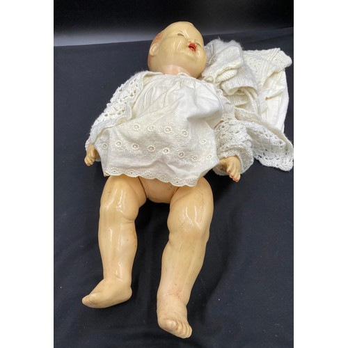 762 - A vintage celluloid doll with unassociated doll's clothes. length 62cm.