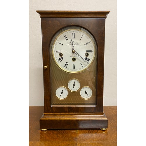 626 - A walnut cased mantle clock calendar by Knight & Gibbons, London on bun feet. 36cm high. Chimes and ... 