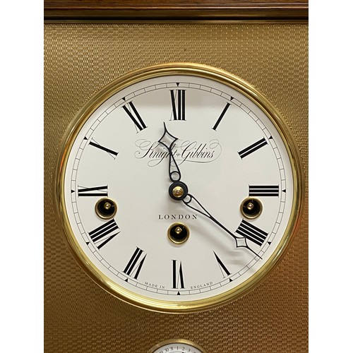 626 - A walnut cased mantle clock calendar by Knight & Gibbons, London on bun feet. 36cm high. Chimes and ... 