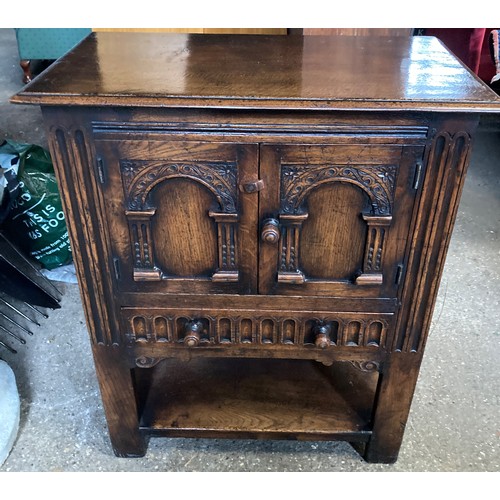 1195 - A carved oak cabinet, 2 doors over single drawer 69 w x 38 x 82cm h. Label to back. G T Rackstraw Lt... 