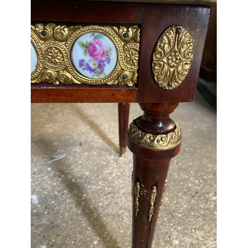 1196 - A French style marble topped coffee table with porcelain plaques and gilt mounts 99 w x 50 x 49cm.