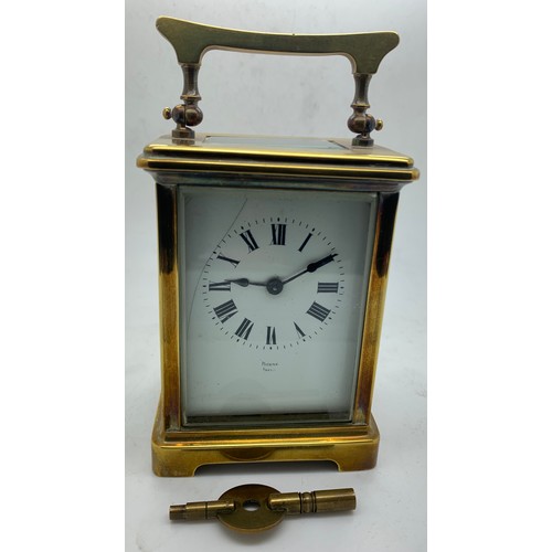 666 - A French brass cased carriage clock with white enamel face and Roman dial stamp 'Byrne Paris'. Key i... 