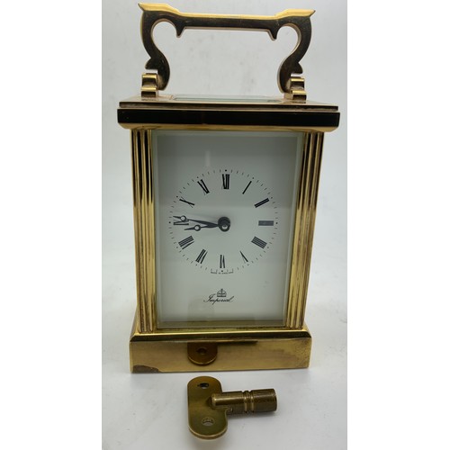 667 - An 'Imperial' brass carriage clock with key. Winds and goes. 15cm h with handle up.