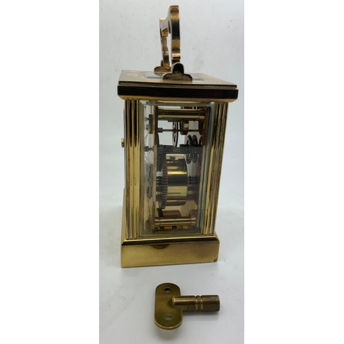 667 - An 'Imperial' brass carriage clock with key. Winds and goes. 15cm h with handle up.