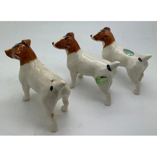 135 - Three Beswick dogs, two with original paper labels, tallest 7cm h.