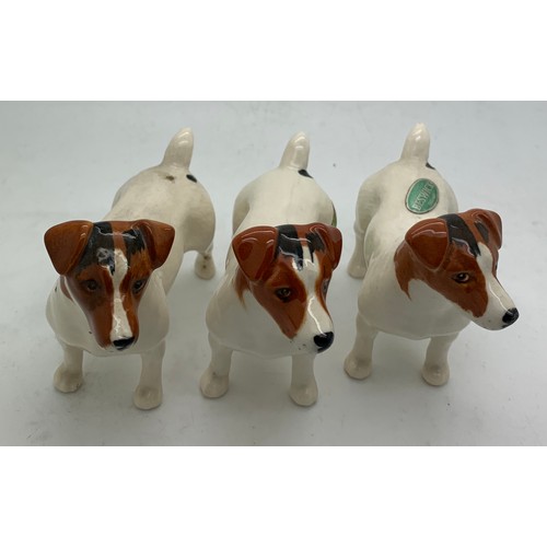 135 - Three Beswick dogs, two with original paper labels, tallest 7cm h.