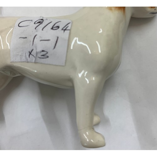 135 - Three Beswick dogs, two with original paper labels, tallest 7cm h.