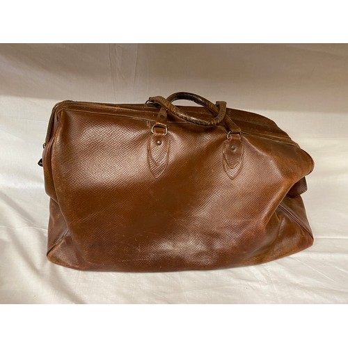 498 - A vintage brown leather suitcase contents to include a 1930's silk velvet bias cut green dress. Peti... 