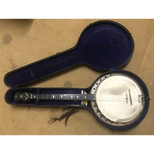 793 - A four string banjo by Barnes Bros of 23 Wood Street, Woolwich London with chrome body and wooden ba... 