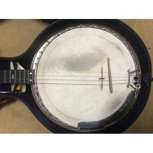 793 - A four string banjo by Barnes Bros of 23 Wood Street, Woolwich London with chrome body and wooden ba... 