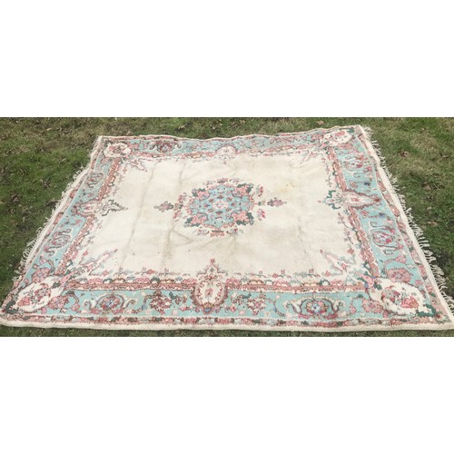 513 - Large floral patterned wool rug, cream panel with blue border. 265 x 221cm.