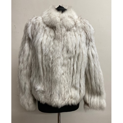 496 - A silver fox fur jacket. Size 12. Approx 52cm from shoulder to hem.