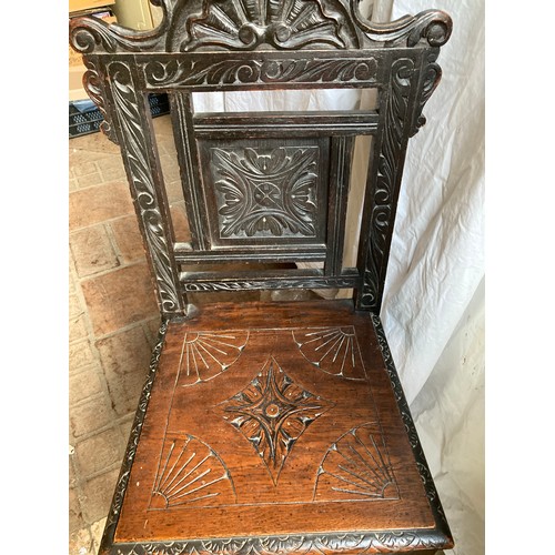 1200 - A carved oak hall chair, height to seat 46cm x back 100cm, width 46cm.