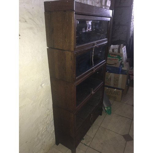 1202 - Oak four height fold over door bookcase, drawer to base, glass shelves. 157 h x 87 w x 29cm d.