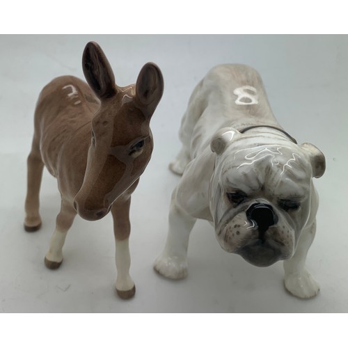 125 - A Beswick donkey together with a Royal Doulton bulldog.