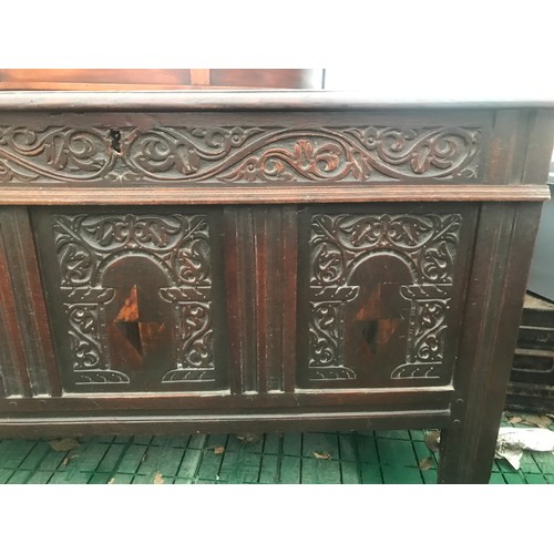 1122 - Seventeenth century oak coffer with inlaid front panels. 124 w x 57 d x 73cm h.