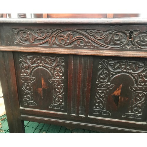 1122 - Seventeenth century oak coffer with inlaid front panels. 124 w x 57 d x 73cm h.