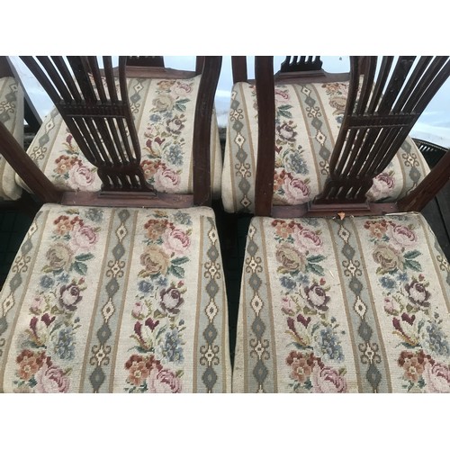 1129 - Set of 10 oak dining chairs, 8 dining and 2 carver chairs, carved backs, woolwork upholstered seats,... 