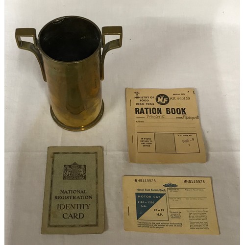 121 - A Trench art double handled brass vase made from a shell 17cm h x 13cm w, a 1953/54 ration book, a m... 