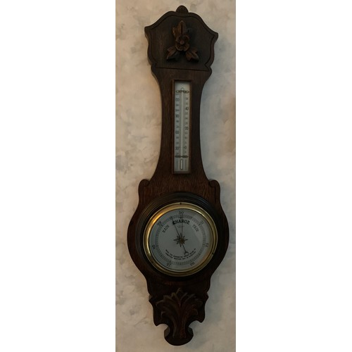 668 - An oak aneroid barometer 68cm h.