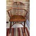 A 19thC low back ash/elm Windsor armchair with crinoline stretcher.