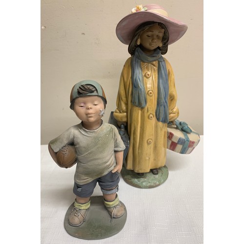 114 - A Lladro figurine, a girl with  suitcase and hatbox 28cm h together with an Elisa figure of a boy wi... 