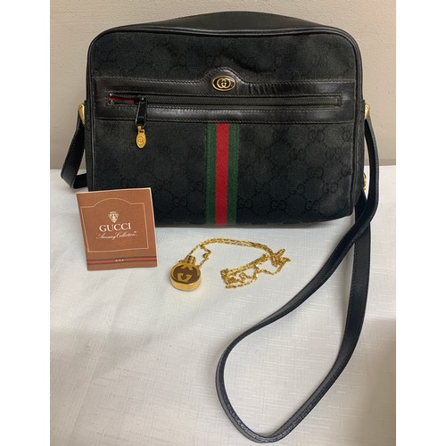 504 - A vintage Gucci handbag and Gucci pendant scent bottle in original tissue.