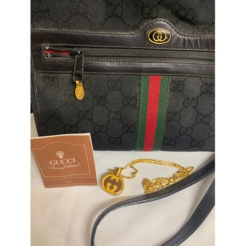 504 - A vintage Gucci handbag and Gucci pendant scent bottle in original tissue.