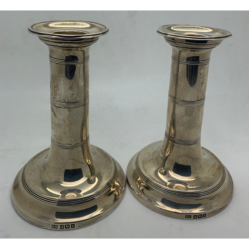 437 - Pair of silver candlesticks, Sheffiels 1906, maker Harrison Bothers & Howson, 12cm h. Weighted bases... 