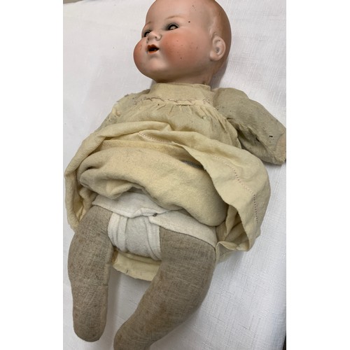 704 - Bisque headed Armand Marseille doll with closing blue eye and open mouth with cloth body and plastic... 