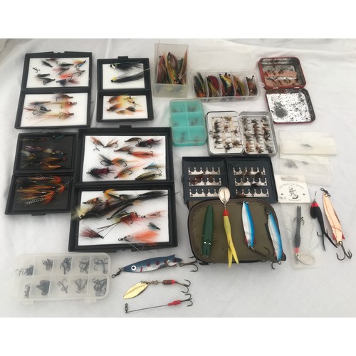 767 - Quantity of fly fishing feather hooks with cases, spinning lures and treble hooks and a cloth bag.