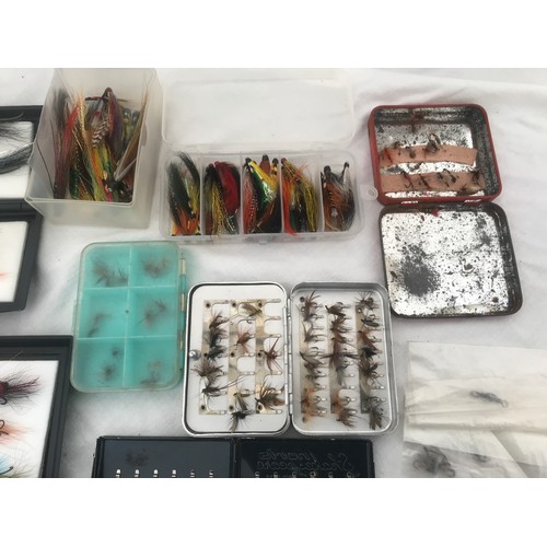 767 - Quantity of fly fishing feather hooks with cases, spinning lures and treble hooks and a cloth bag.